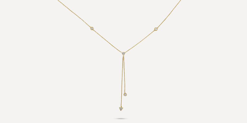 Plunging chains accompanied by bezel set triangle and brilliant diamonds set in yellow gold. Dainty yet timeless, perfect for layering to complement a women's neckline.  Estimated Diamond Weight: 0.71 carat of diamond  Gold Weight: 18k Yellow gold