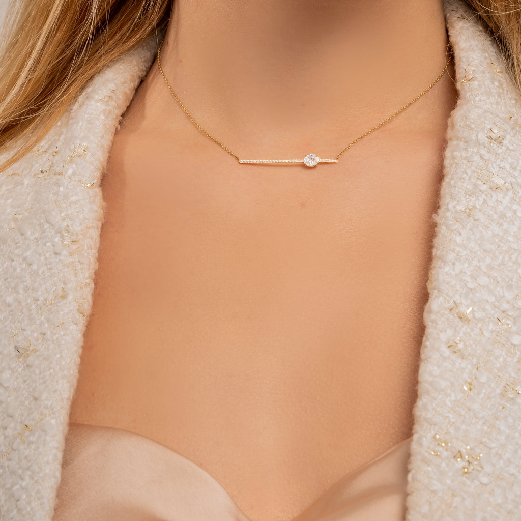 Sits perfectly on the neckline accentuating the collar bones. Yellow gold chain with a dainty line of melee white diamonds embellishing an invisibly set white brilliant diamond.   Estimated Diamond Weight: 0.43 Carat Of Diamond   Gold Weight: 18K Yellow Gold