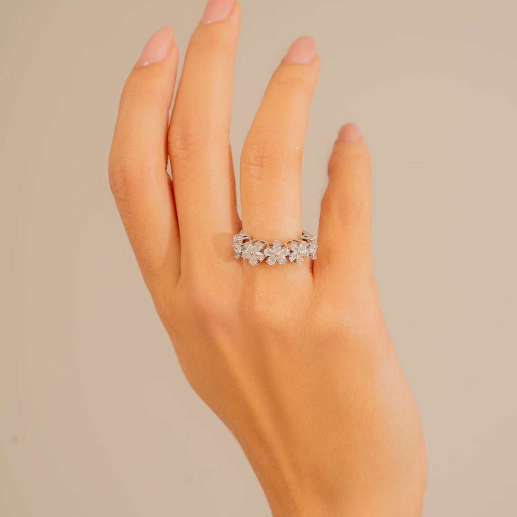 Half eternity pear-cut diamond ring features exquisitely embellished petal shaped white diamonds aligned in a set of five capturing a feminine allure.  Estimated Diamond Weight: 1.33 carats of diamond. Gold Weight: 18k white gold.
