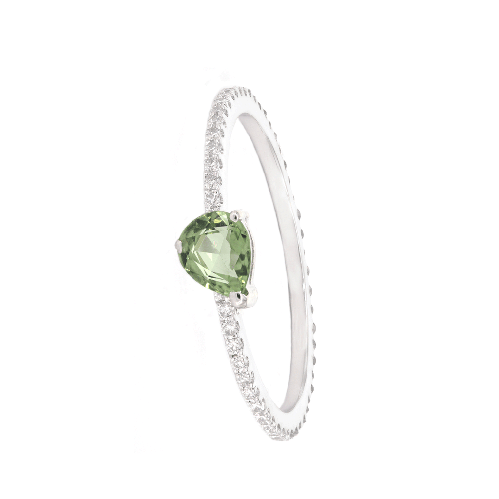 White diamond pavé-set skinny ring with a new twist on the classic pear-cut green sapphire set on white gold at its finest. This modern finish sits weightlessly on the fingers enhanced by glittering green sapphire radiance.  Estimated Diamond Weight: 0.26carat of diamond  Estimated Colored Stone Weight: 0.40carat of sapphire Gold Weight: 18k Yellow gold