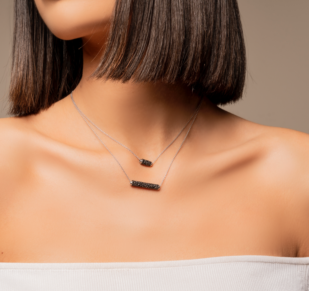 This black diamond swivel necklace sits perfectly on your décolleté. White gold chain necklace with a melee embellished black diamond charm pendant.   